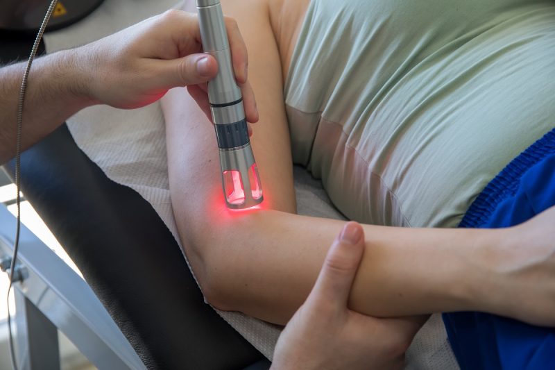 Laser therapy in hand used to treat pain. selective focus